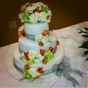 CBD white wedding cake with light grey ribbonw bow and flowers